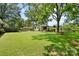 Expansive backyard featuring a well-maintained lawn, storage shed, and mature trees at 1104 Pump Station Rd, Kannapolis, NC 28081