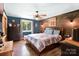 Cozy bedroom with wood accent wall, a comfortable bed, and natural light, creating a serene retreat at 1104 Pump Station Rd, Kannapolis, NC 28081