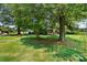 Expansive lawn and mature trees surround this home, with covered parking nearby at 1104 Pump Station Rd, Kannapolis, NC 28081