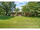 Charming brick home with a welcoming front porch, lush lawn, and mature trees, offering curb appeal at 1104 Pump Station Rd, Kannapolis, NC 28081