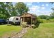 Exterior of charming cottage with manicured lawn and mature trees at 1104 Pump Station Rd, Kannapolis, NC 28081