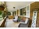 Cozy front porch with comfortable wicker seating, hanging plants, and classic brick exterior at 1104 Pump Station Rd, Kannapolis, NC 28081