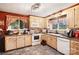Well-lit kitchen features bright cabinets, granite countertops, and modern appliances, perfect for cooking enthusiasts at 1104 Pump Station Rd, Kannapolis, NC 28081