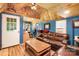 Cozy living room featuring a comfortable brown leather sofa, blue walls, and wood flooring at 1104 Pump Station Rd, Kannapolis, NC 28081