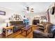 Inviting living room with cozy seating, wood floors, and an aquarium that adds a calming touch at 1104 Pump Station Rd, Kannapolis, NC 28081