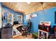 Bright, blue office space with wood accents and a corner desk illuminated by a window with photos and a microwave at 1104 Pump Station Rd, Kannapolis, NC 28081
