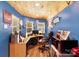 Bright, blue office space with wood accents and a corner desk illuminated by a window with photos and a microwave at 1104 Pump Station Rd, Kannapolis, NC 28081