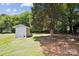 Backyard with shed and many shady trees at 1108 4Th St, Statesville, NC 28677