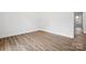 A light vinyl floor graces this bedroom with bright white walls and trim at 1108 4Th St, Statesville, NC 28677