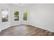 This bright bedroom has light vinyl flooring, crisp white walls, and two large windows at 1108 4Th St, Statesville, NC 28677