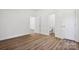 This bright bedroom has light vinyl flooring and crisp white walls and trim at 1108 4Th St, Statesville, NC 28677