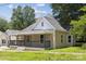 Charming home featuring a cozy front porch, neutral siding, and a well-maintained lawn at 1108 4Th St, Statesville, NC 28677