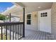 Inviting front porch with white door, modern light fixture, and painted wooden deck at 1108 4Th St, Statesville, NC 28677