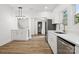Modern kitchen with white cabinets, stainless steel appliances, and luxury vinyl plank flooring at 1108 4Th St, Statesville, NC 28677