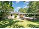 The house is set back from the street and surrounded by green foliage at 1138 Laurel St, Salisbury, NC 28144
