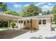View of the exterior featuring a brick house with a covered parking area at 1138 Laurel St, Salisbury, NC 28144