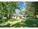Back view of house and yard surrounded by lush, mature trees at 1138 Laurel St, Salisbury, NC 28144