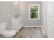 Bathroom with a modern single sink vanity, toilet, and window at 1138 Laurel St, Salisbury, NC 28144