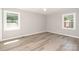 Inviting bedroom featuring two bright windows that illuminate grey walls and durable light wood-look floors at 1138 Laurel St, Salisbury, NC 28144
