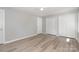 Comfortable bedroom featuring spacious closets, sleek gray walls, and durable light wood-look floors at 1138 Laurel St, Salisbury, NC 28144