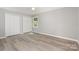 Bright bedroom featuring spacious closets, sleek gray walls, and durable light wood-look floors at 1138 Laurel St, Salisbury, NC 28144