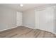 Comfortable bedroom featuring spacious closets, sleek gray walls, and durable light wood-look floors at 1138 Laurel St, Salisbury, NC 28144