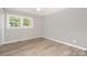 Bright bedroom featuring two bright windows that illuminate grey walls and durable light wood-look floors at 1138 Laurel St, Salisbury, NC 28144