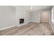 Spacious living room featuring wood floors, a brick fireplace, and neutral paint at 1138 Laurel St, Salisbury, NC 28144