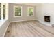 Bright living room features wood flooring, white trim, and large windows at 1138 Laurel St, Salisbury, NC 28144