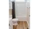 Clean bathroom featuring shower and tub, toilet, wood-look floors, and neutral walls at 118 Cypress Acres Ln, Statesville, NC 28625