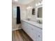 Bathroom featuring double sink vanity with neutral counter tops, decorative mirrors, and warm lighting at 118 Cypress Acres Ln, Statesville, NC 28625