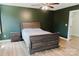 Cozy bedroom with a wooden bed frame, accent wall, and wood-look flooring at 118 Cypress Acres Ln, Statesville, NC 28625