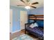 ' bedroom with blue walls, wood-look floors, and a bunk bed at 118 Cypress Acres Ln, Statesville, NC 28625