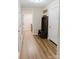 Hallway with wood-look floors, a bench with storage, and access to laundry room and additional rooms at 118 Cypress Acres Ln, Statesville, NC 28625