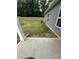 A view of the backyard featuring a grey house and a well-maintained lawn at 1411 Cottage Green Dr # 218, Monroe, NC 28112