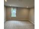 Bedroom featuring neutral walls, carpet flooring, and a window with natural light at 1411 Cottage Green Dr # 218, Monroe, NC 28112
