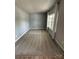 This cozy bedroom has a big window with curtains and carpeted floors at 1411 Cottage Green Dr # 218, Monroe, NC 28112
