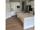 This bright kitchen has a stainless steel refrigerator and a large white island at 1411 Cottage Green Dr # 218, Monroe, NC 28112