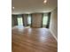 An expansive living room featuring hardwood floors, natural light and recessed lighting at 1411 Cottage Green Dr # 218, Monroe, NC 28112