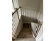 Carpeted stairway featuring an oak banister and white walls at 1411 Cottage Green Dr # 218, Monroe, NC 28112