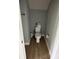 Powder room with toilet, wood look flooring, and light gray walls at 1411 Cottage Green Dr # 218, Monroe, NC 28112