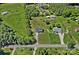 Aerial view of the home, back yard, surrounding neighborhood, and mature trees at 142 Family Ln, Mount Holly, NC 28120