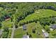 Aerial view showcasing the home's roof, back yard, and natural surroundings at 142 Family Ln, Mount Holly, NC 28120