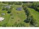 Aerial view of the home surrounded by a spacious, green back yard and mature trees at 142 Family Ln, Mount Holly, NC 28120