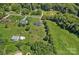 Aerial view showing the home, landscaping, surrounding neighborhood, and large back yard at 142 Family Ln, Mount Holly, NC 28120