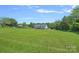 A sprawling green back yard and a view of the home's back porch at 142 Family Ln, Mount Holly, NC 28120