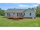 Backyard with deck, great outdoor seating, and lush green grass at 142 Family Ln, Mount Holly, NC 28120