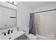 Bathroom featuring a sleek vanity with matte black fixtures and shower with curtain at 142 Family Ln, Mount Holly, NC 28120