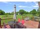Back deck with table and chairs, grill, and expansive backyard views at 142 Family Ln, Mount Holly, NC 28120