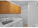 Functional laundry room with white appliances and ample storage at 142 Family Ln, Mount Holly, NC 28120
